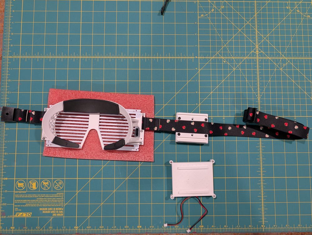 Assembly parts laid out, with the strap across the compute pack's rails